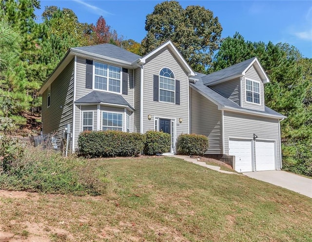 view of front of property featuring a garage and a front lawn