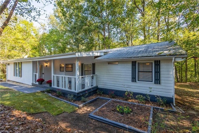 rear view of house featuring covered porch