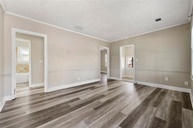 empty room featuring dark hardwood / wood-style flooring and ornamental molding