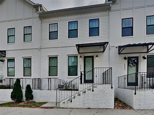 multi unit property featuring brick siding and board and batten siding