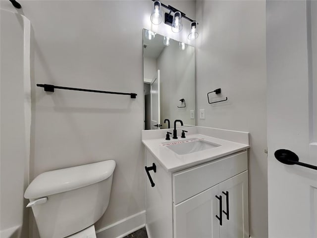 bathroom featuring toilet and vanity