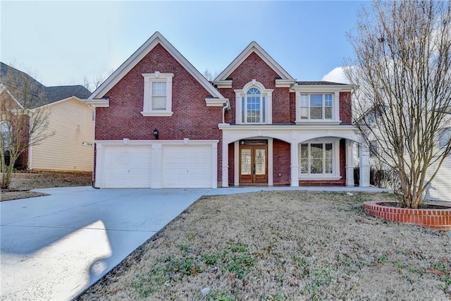 1417 Wind Chime Ct, Lawrenceville, GA 30045 - view of front facade with french doors, brick siding, a garage, concrete driveway, and covered porch