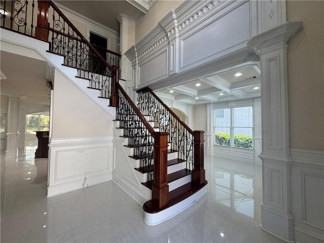 1417 Wind Chime Ct, Lawrenceville, GA 30045 - stairway with ornate columns, a decorative wall, crown molding, tile patterned floors, and coffered ceiling