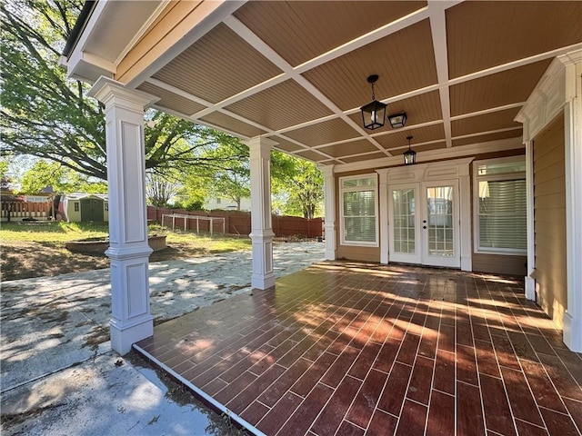 1417 Wind Chime Ct, Lawrenceville, GA 30045 - wooden deck featuring french doors, a storage unit, and a patio area