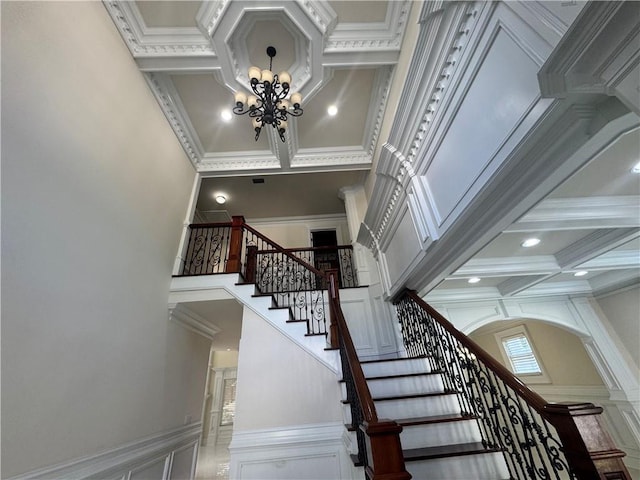 1417 Wind Chime Ct, Lawrenceville, GA 30045 - staircase featuring a towering ceiling, coffered ceiling, a chandelier, ornamental molding, and beamed ceiling
