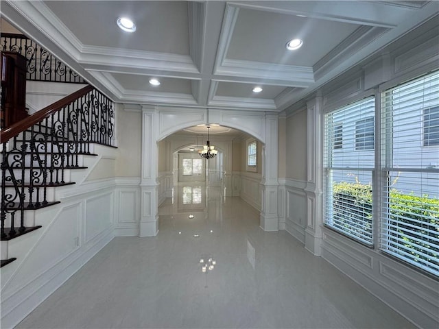 1417 Wind Chime Ct, Lawrenceville, GA 30045 - hall featuring arched walkways, a decorative wall, decorative columns, coffered ceiling, and a chandelier