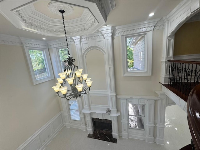1417 Wind Chime Ct, Lawrenceville, GA 30045 - detailed view of a chandelier, a decorative wall, crown molding, and a tray ceiling