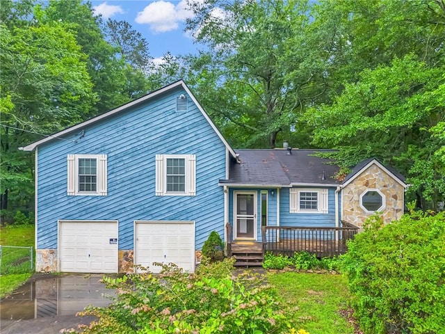 2419 Anderson Mill Rd, Austell, GA 30106 - view of front of property with stone siding, driveway, an attached garage, and a deck