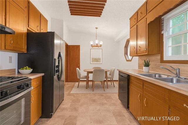 2419 Anderson Mill Rd, Austell, GA 30106 - kitchen featuring black appliances, brown cabinets, light countertops, a chandelier, and lofted ceiling