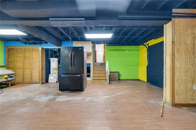 2419 Anderson Mill Rd, Austell, GA 30106 - below grade area featuring gas water heater, freestanding refrigerator, wood finished floors, and a garage