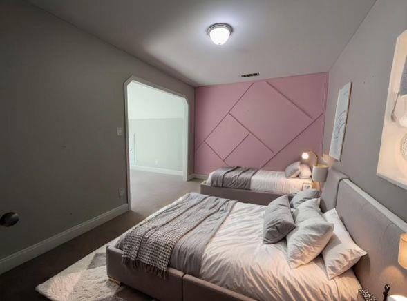 bedroom featuring visible vents and baseboards