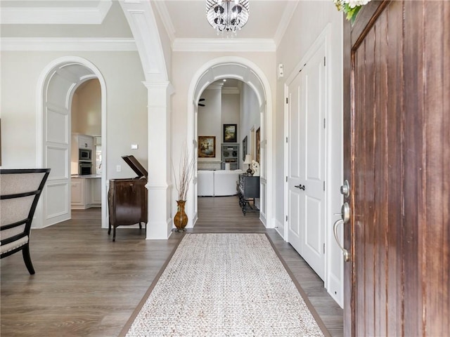 5964 Chickasaw Ln, Braselton, GA 30517 - foyer entrance with ornamental molding, arched walkways, and dark wood-type flooring