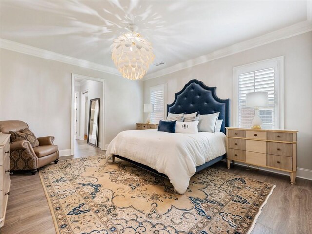 5964 Chickasaw Ln, Braselton, GA 30517 - bedroom featuring ornamental molding, a notable chandelier, light wood finished floors, and visible vents