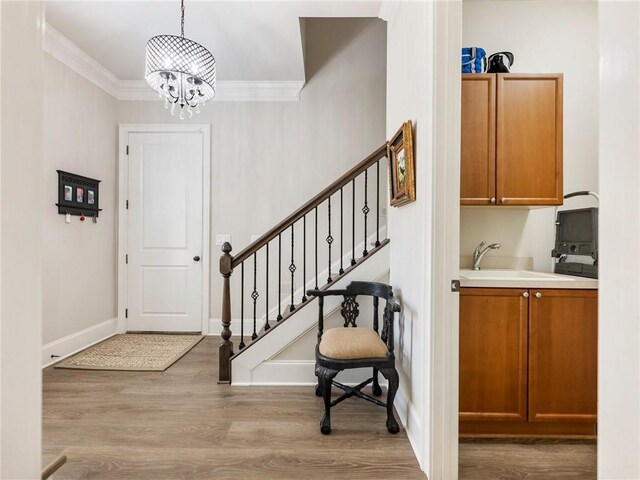 5964 Chickasaw Ln, Braselton, GA 30517 - entrance foyer with crown molding, stairway, an inviting chandelier, baseboards, and wood finished floors