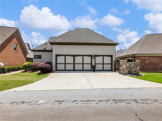 5964 Chickasaw Ln, Braselton, GA 30517 - view of front of property with a garage, a front yard, driveway, and stucco siding