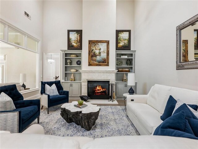 5964 Chickasaw Ln, Braselton, GA 30517 - living area with a high end fireplace, a towering ceiling, and visible vents