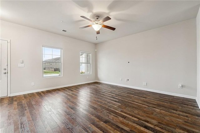 spare room with dark hardwood / wood-style floors and ceiling fan