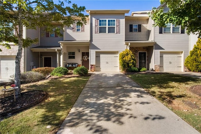 multi unit property featuring a garage and a front lawn