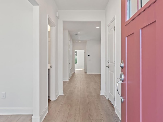 corridor with light wood-type flooring