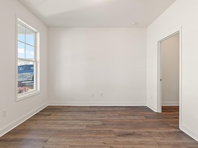 spare room featuring dark wood-type flooring