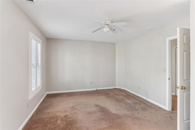 spare room with a ceiling fan, baseboards, and carpet floors