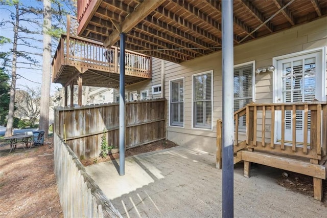 view of patio / terrace with a deck and fence