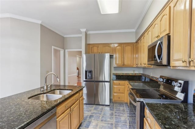 kitchen featuring a sink, stainless steel appliances, dark stone countertops, and crown molding