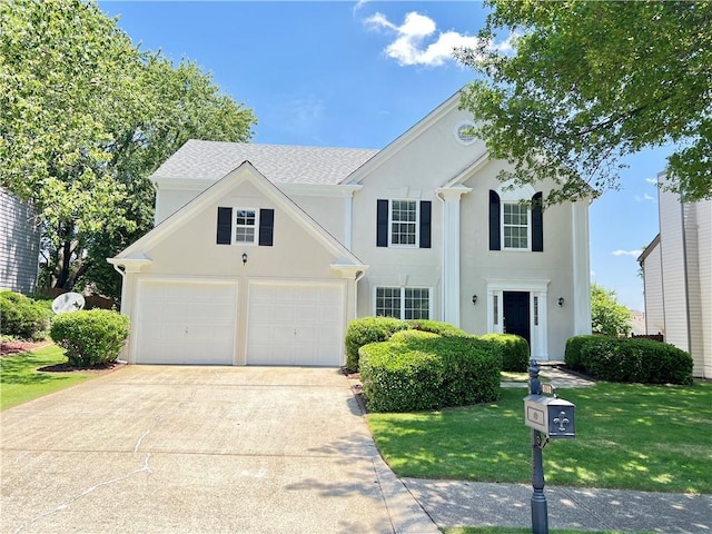 2130 Chattahoochee Dr, Duluth, GA 30097 - view of front of house featuring a garage, driveway, a front yard, and stucco siding