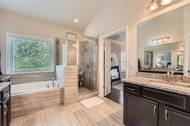 2433 Santa Rosa St, Alpharetta, GA 30009 - full bathroom with vanity, a garden tub, a shower stall, lofted ceiling, and recessed lighting