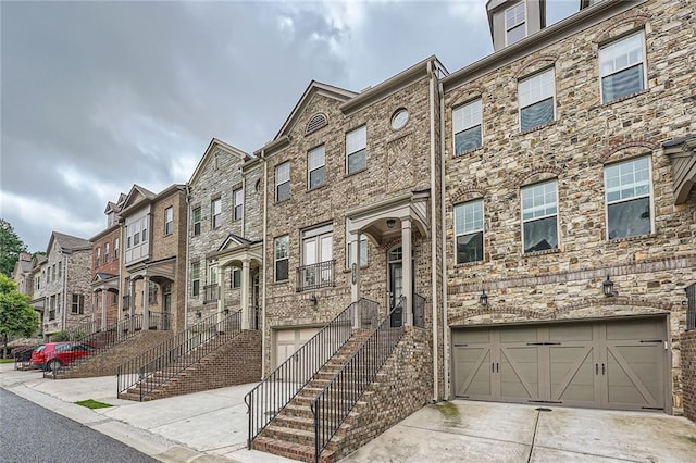 2433 Santa Rosa St, Alpharetta, GA 30009 - townhome / multi-family property with an attached garage, driveway, and a residential view