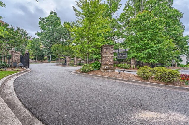 2433 Santa Rosa St, Alpharetta, GA 30009 - view of asphalt road featuring curbs and a gated entry