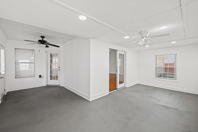 empty room with ceiling fan, concrete flooring, and recessed lighting