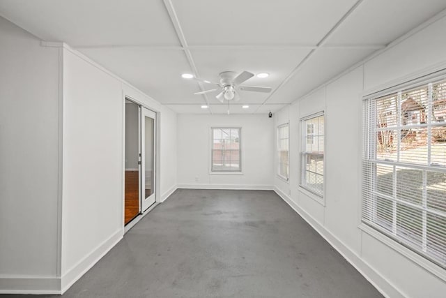 spare room featuring ceiling fan, concrete floors, baseboards, and recessed lighting