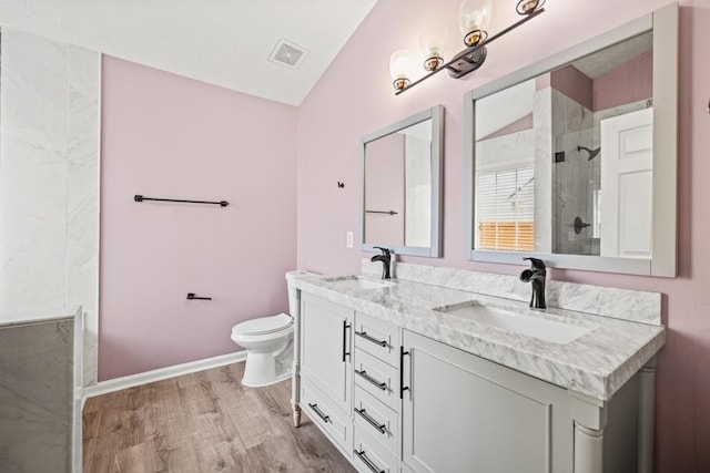 full bath featuring a tile shower, toilet, a sink, and visible vents