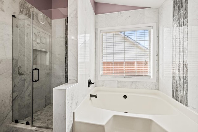 full bathroom featuring lofted ceiling, a stall shower, and a garden tub