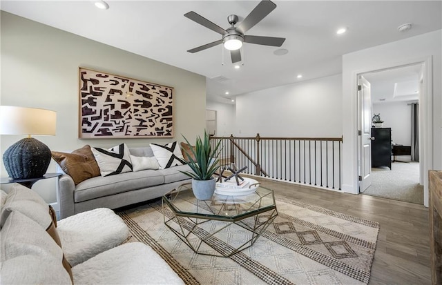 living room featuring ceiling fan and hardwood / wood-style flooring