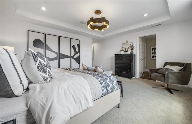 bedroom with a raised ceiling, an inviting chandelier, and carpet flooring