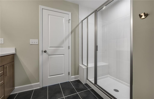 bathroom with vanity, a shower with door, and tile patterned floors