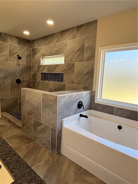 bathroom featuring a walk in shower, tile patterned flooring, a bath, and recessed lighting