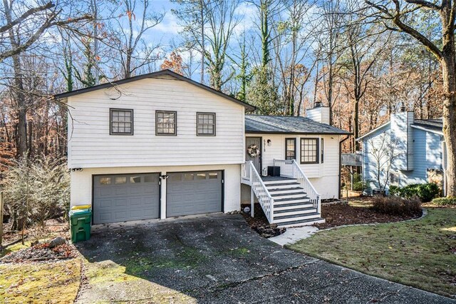 split level home featuring a garage and central air condition unit