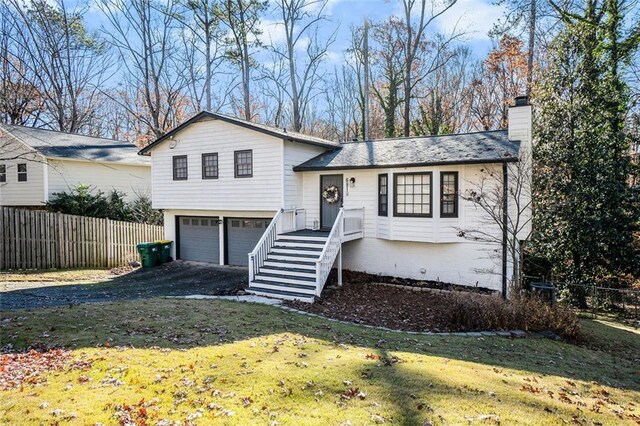 split level home featuring a garage and a front yard