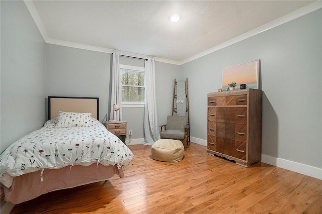 bedroom featuring hardwood / wood-style flooring and crown molding