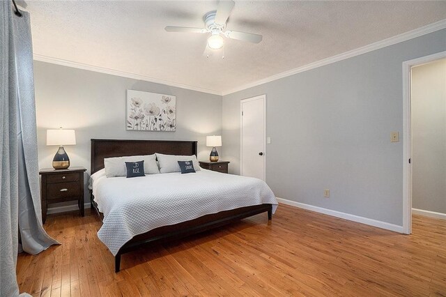 bedroom featuring ceiling fan, hardwood / wood-style floors, and crown molding