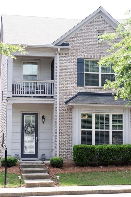 7699 Cabrini Pl, Fairburn, GA 30213 - view of front of house featuring a balcony and brick siding