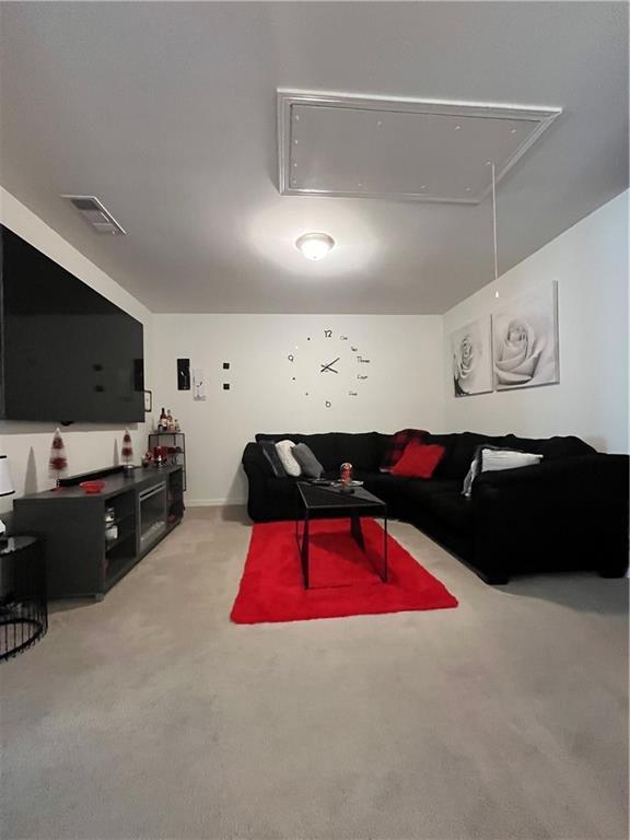7699 Cabrini Pl, Fairburn, GA 30213 - living area with attic access and light carpet