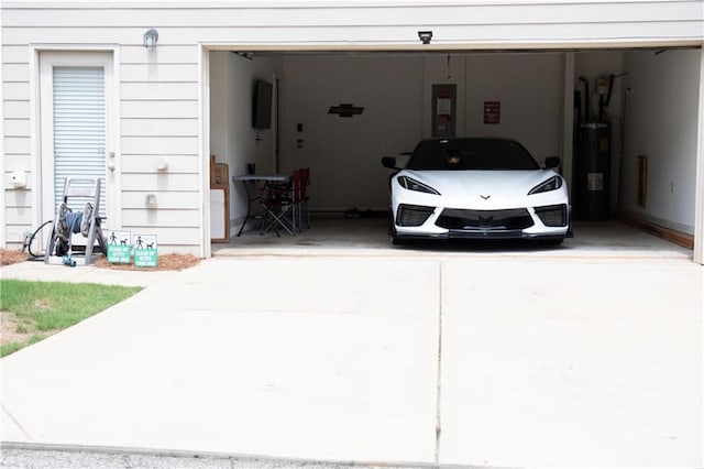 7699 Cabrini Pl, Fairburn, GA 30213 - garage featuring concrete driveway, water heater, and electric panel