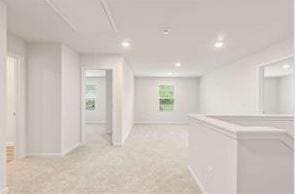 empty room with recessed lighting, washer / clothes dryer, and light colored carpet