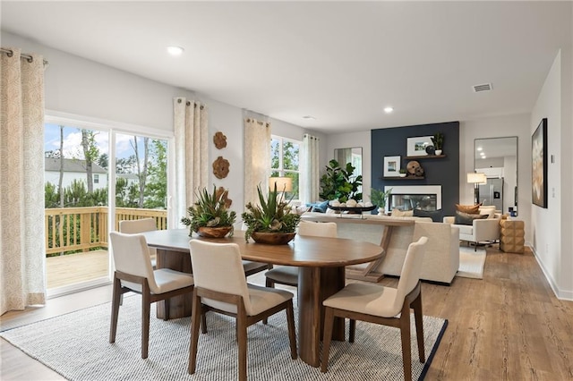 unfurnished living room with a glass covered fireplace and wood finished floors