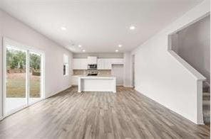 unfurnished living room featuring light wood-style floors and recessed lighting