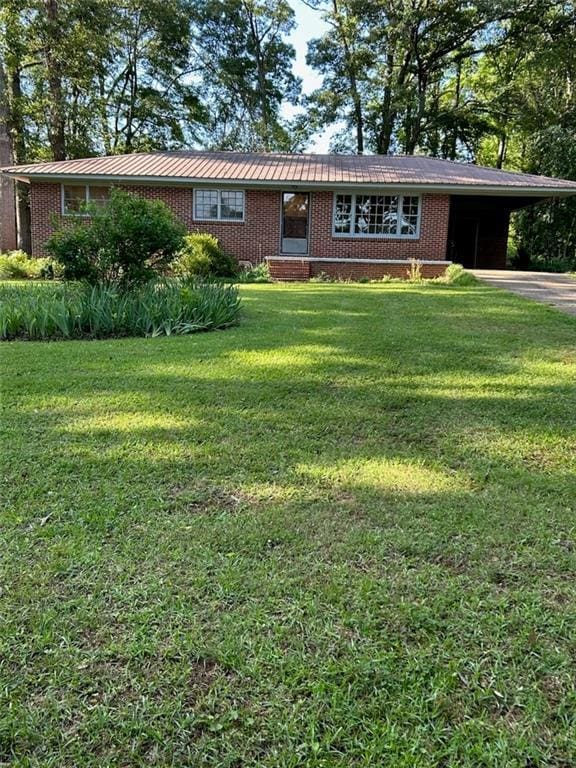 97 Abby Ln, Nicholson, GA 30565 - ranch-style house with brick siding, a carport, a front lawn, metal roof, and driveway